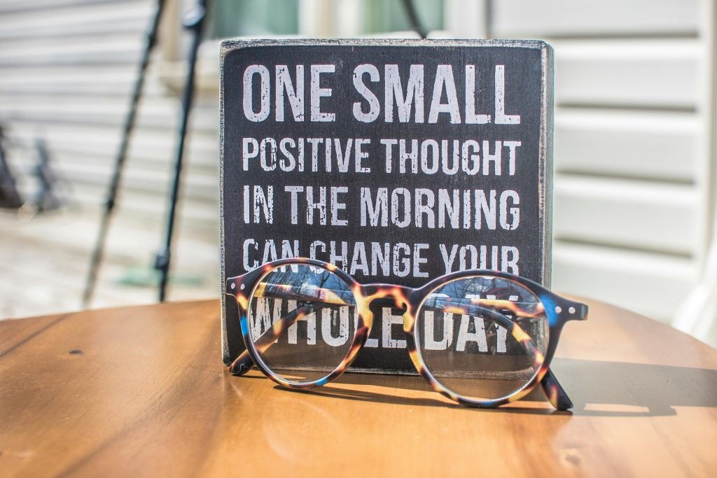 pexels-photo-1485657-1485657 Photo of a Sign and Eyeglasses on Table
