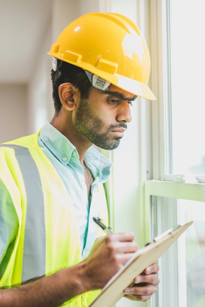 pexels-photo-8293769-8293769 Man in Yellow Hard Hat Holding Pen